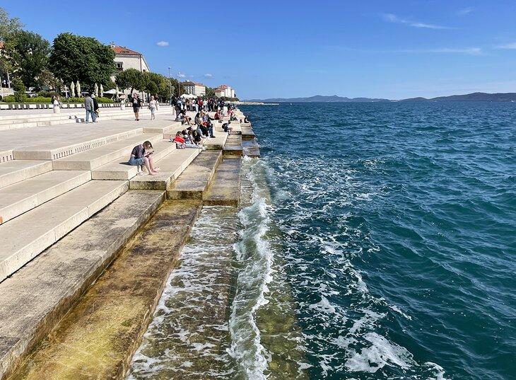 Personas disfrutando del Órgano del Mar en Zadar