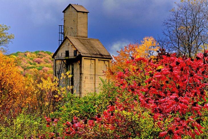 Torre de un patio de trenes abandonado rodeada de colores de otoño en Virginia Occidental