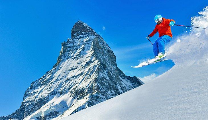 Un esquiador en nieve fresca junto al Matterhorn