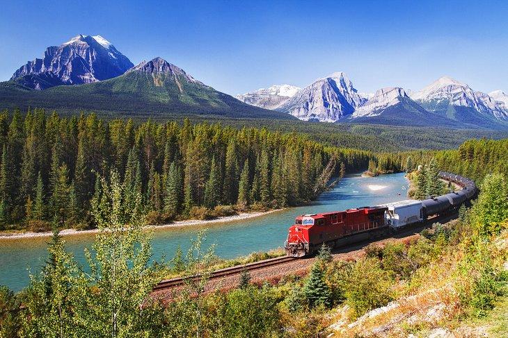 Tren pasando a través del Valle Bow en las Montañas Rocosas Canadienses