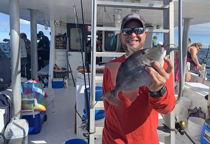 Marinero con un pez loro capturado en Panama City Beach