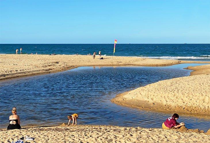 Niños construyendo castillos de arena en Bunbubah Creek, Dicky Beach